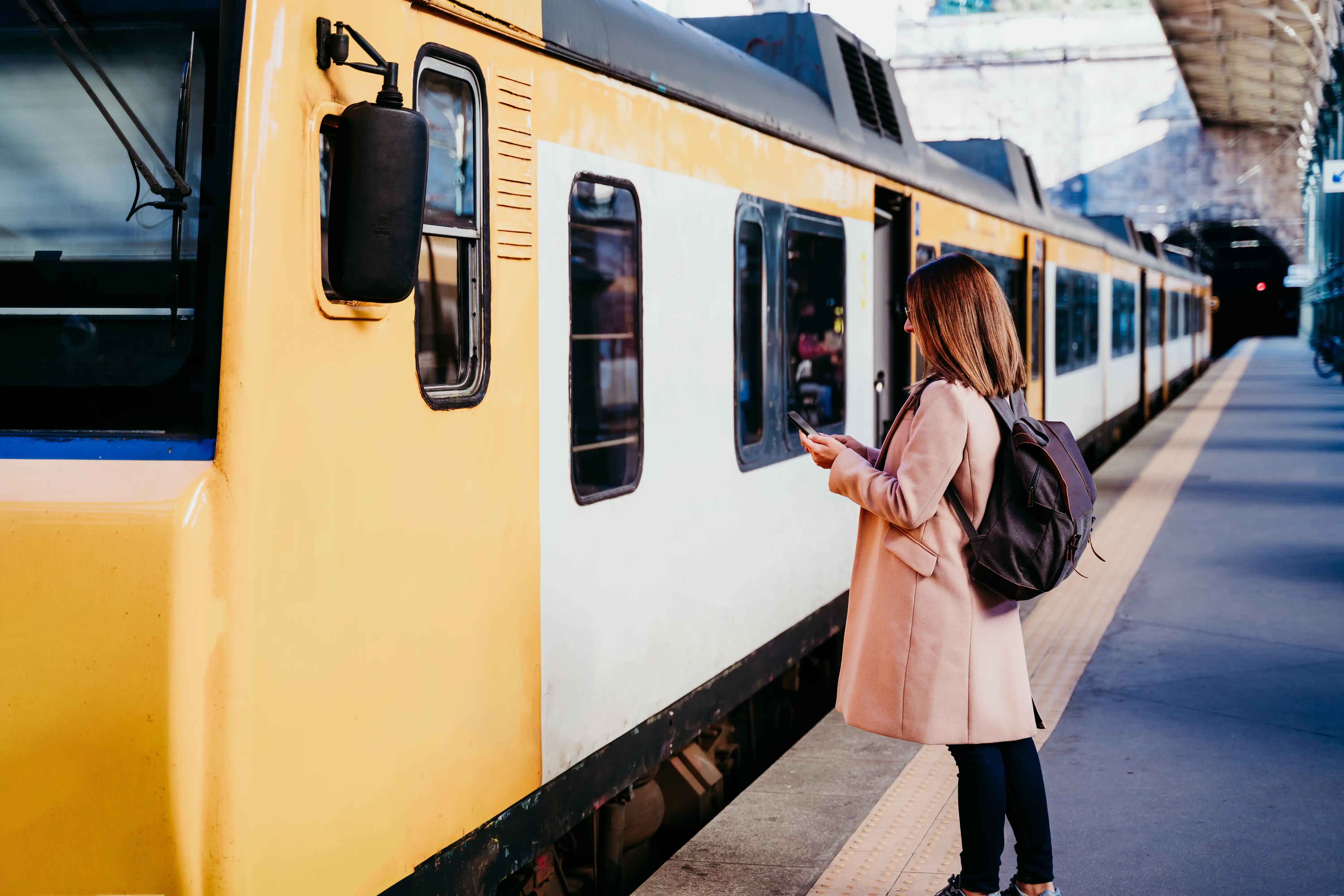 young-woman-at-train-station-using-mobile-phone-t-2023-11-27-05-21-02-utc.webp